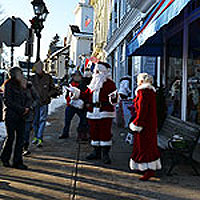 Santa and Mrs. Claus greeting visitors outside Mud Puddle Toys, Pleasant St., Marblehead, Mass.