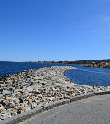 View of rock jetty and Rockport Harbor from tip of Bearskin Neck, Rockport, Ma.